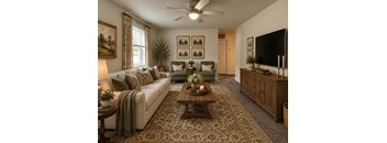 A living room with a couch, a coffee table, and a television.