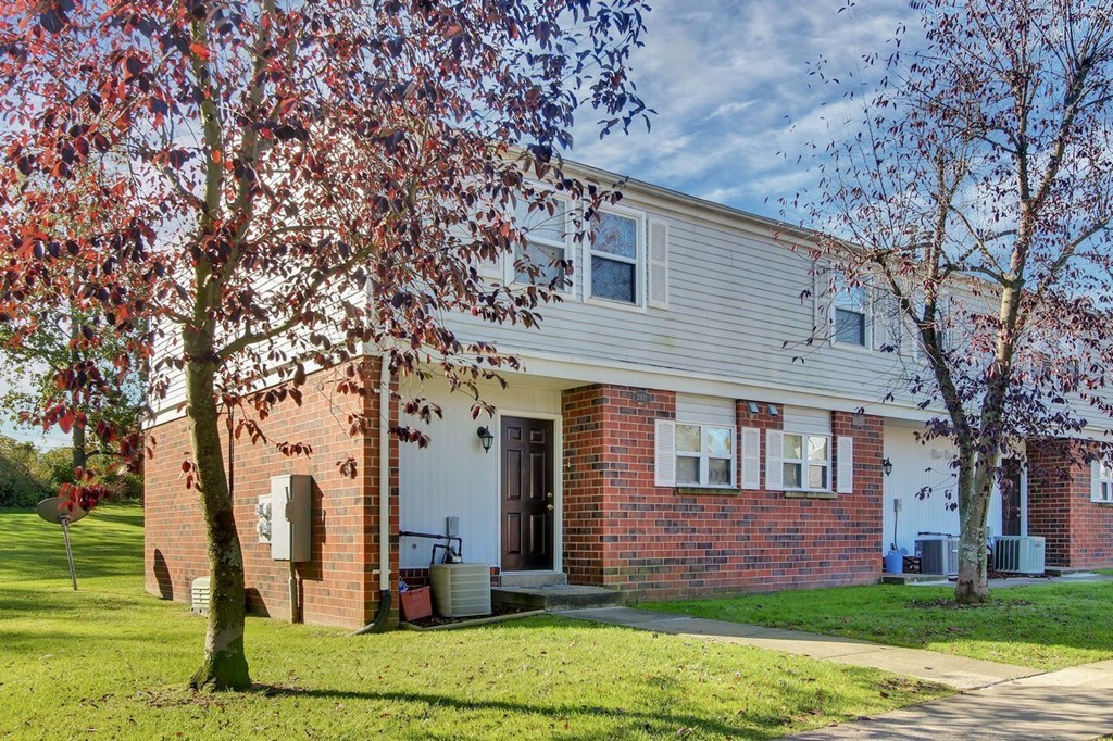 A house with a red brick exterior and a white door.