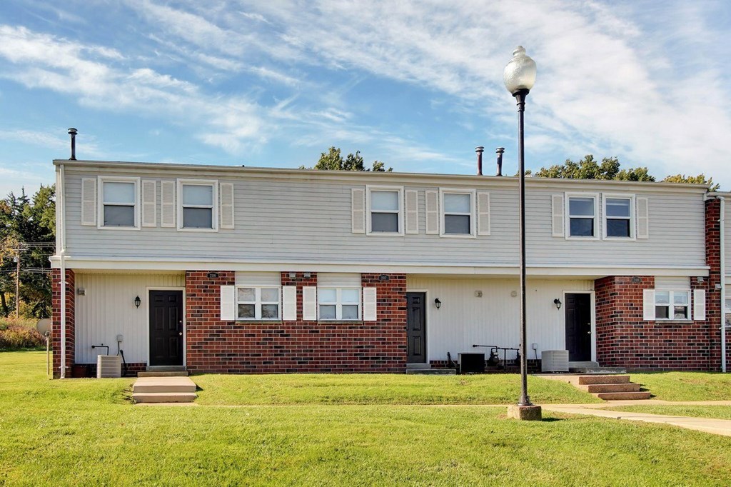 A house with a grey roof and a white door.