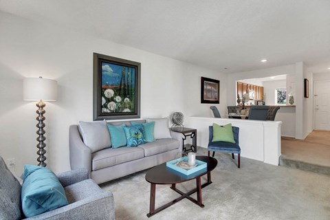 A living room with a grey couch and a coffee table.