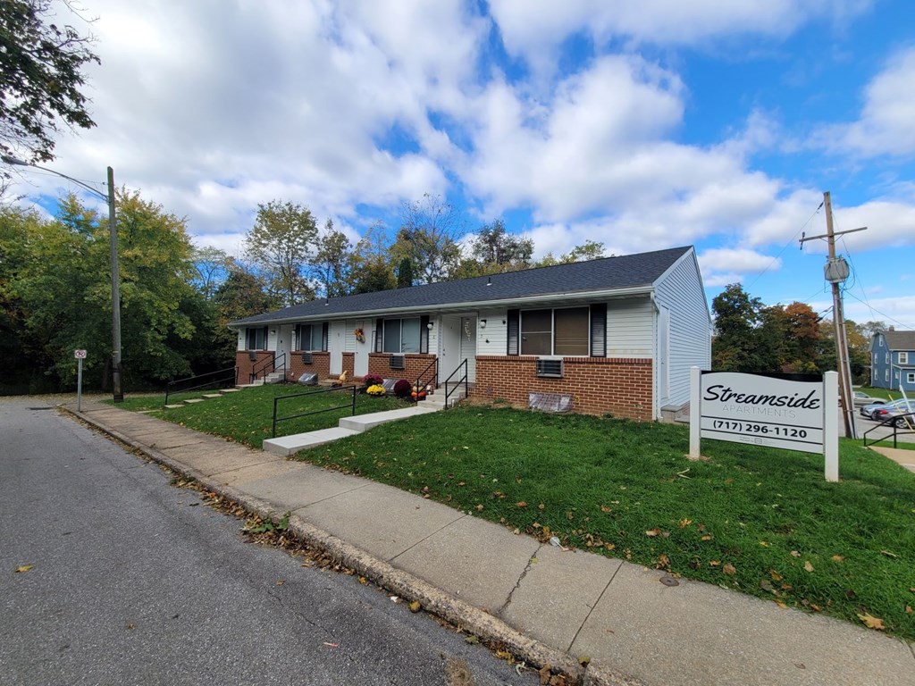 A house with a sign that says Streamside in front of it.