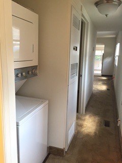 A white oven and fridge in a narrow hallway.