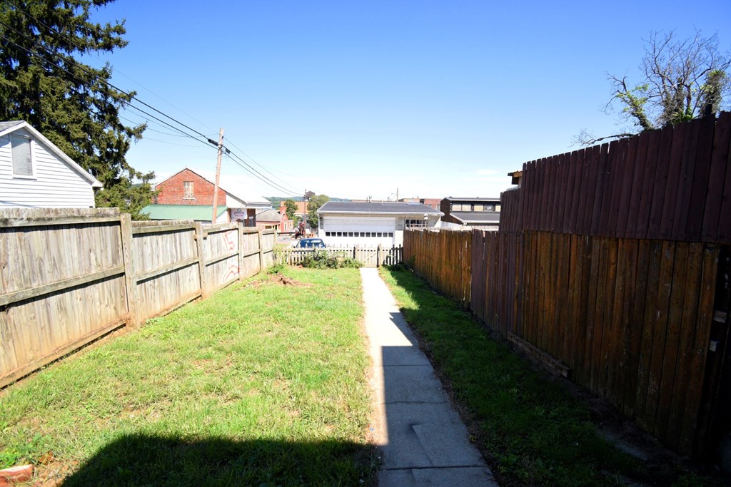 A residential area with houses and a fence.