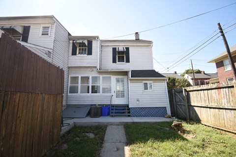 A house with a white exterior and a blue door.