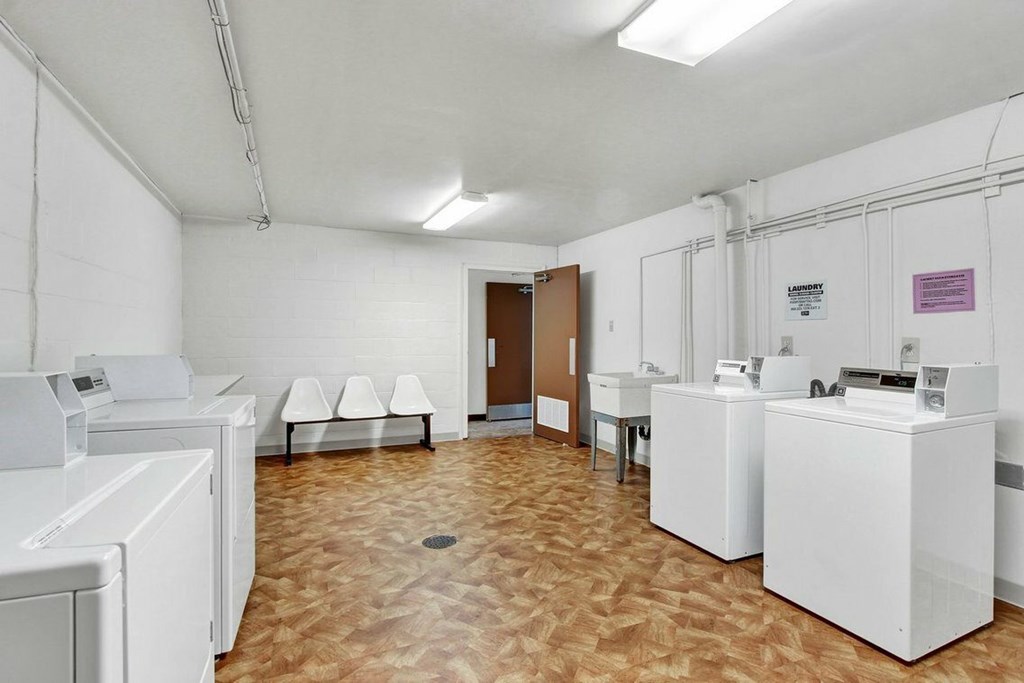 A laundry room with washers and dryers.