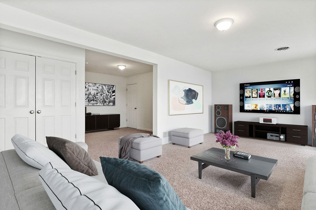 A living room with a grey couch and a coffee table.