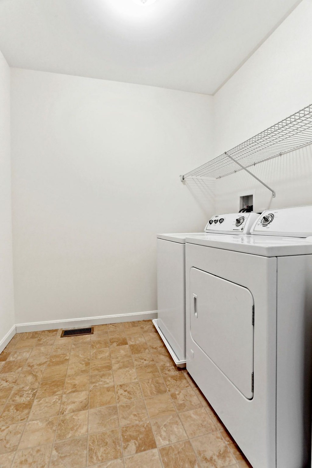 A small laundry room with a washer and dryer.
