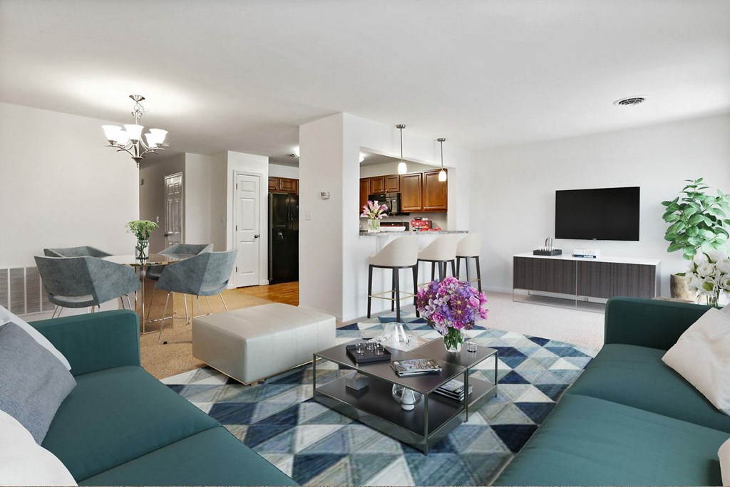 A living room with a green couch and a coffee table.