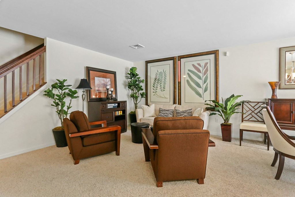 A living room with a brown couch and a white couch.