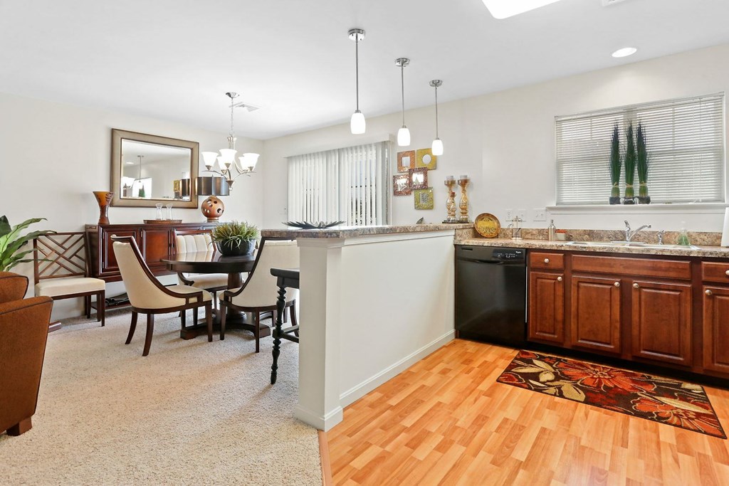 A kitchen with a dining table and chairs.