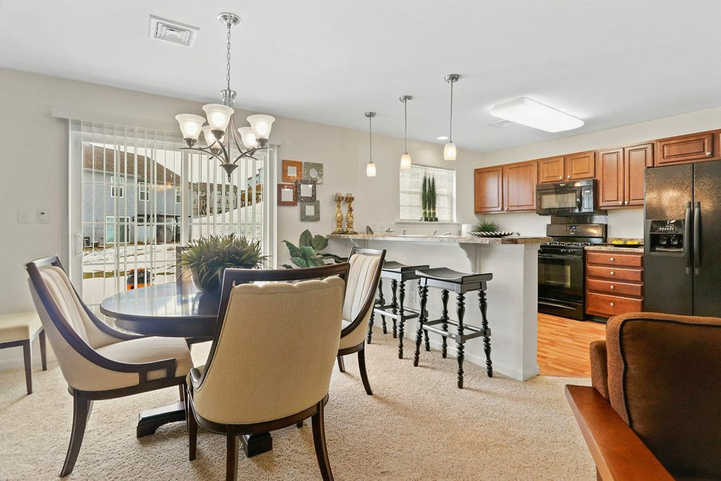 A modern kitchen with a dining table and chairs.