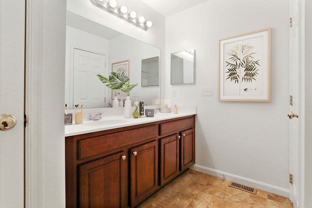 A bathroom with a vanity and a mirror.