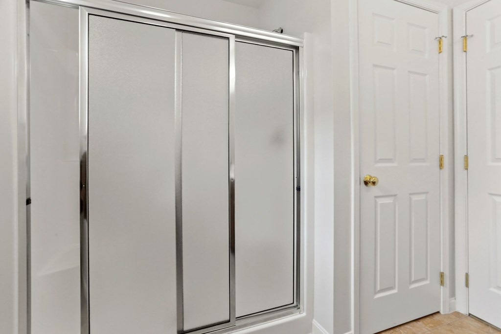 A white door is open to a hallway.