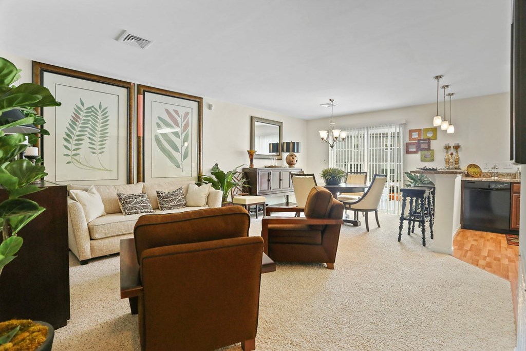 A living room with a brown chair and a white couch.