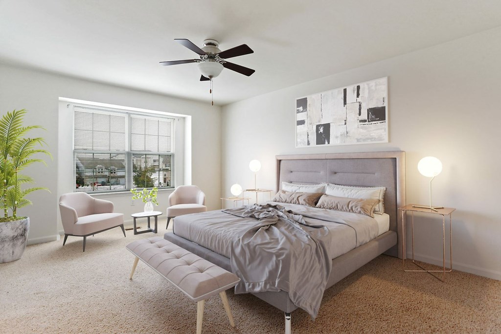A bedroom with a large bed, a ceiling fan, and a window with a view of a cityscape.