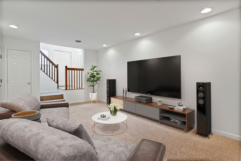 A living room with a grey sofa and a television.