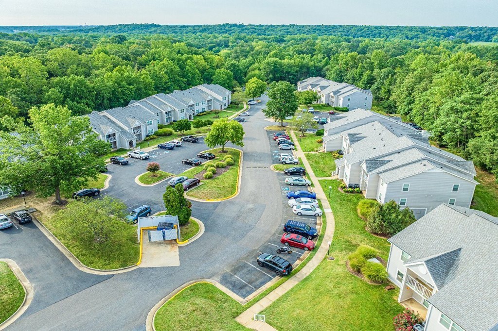 A bird's eye view of a residential area with houses and cars.