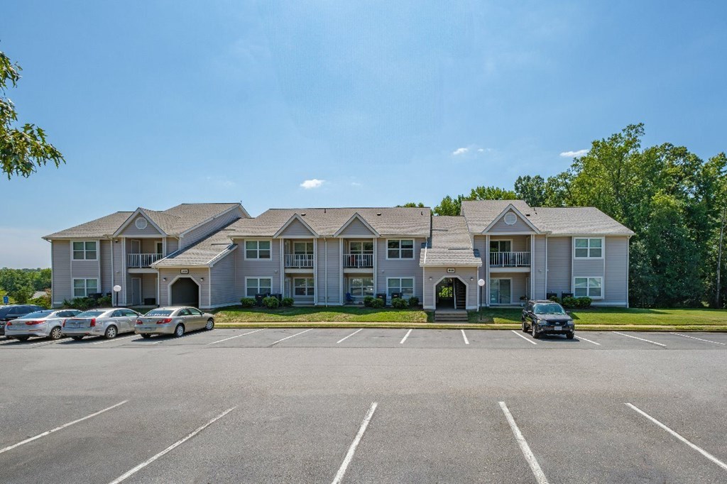 A large building with a parking lot in front of it.