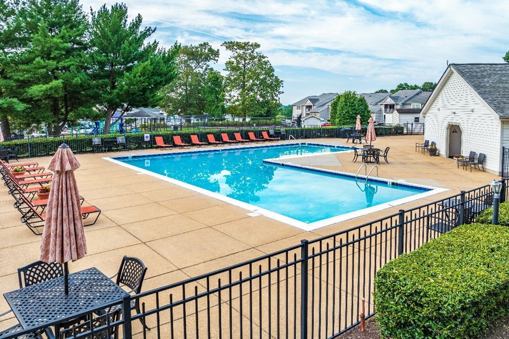 A black metal fence surrounds a small pool.