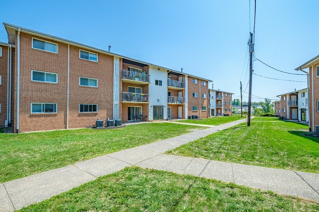A row of apartment buildings with a clear blue sky above.