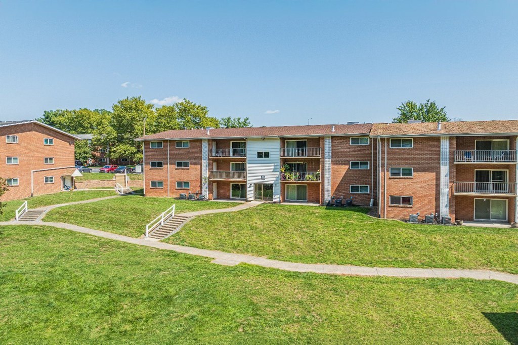 Apartment complex with a green lawn in front.