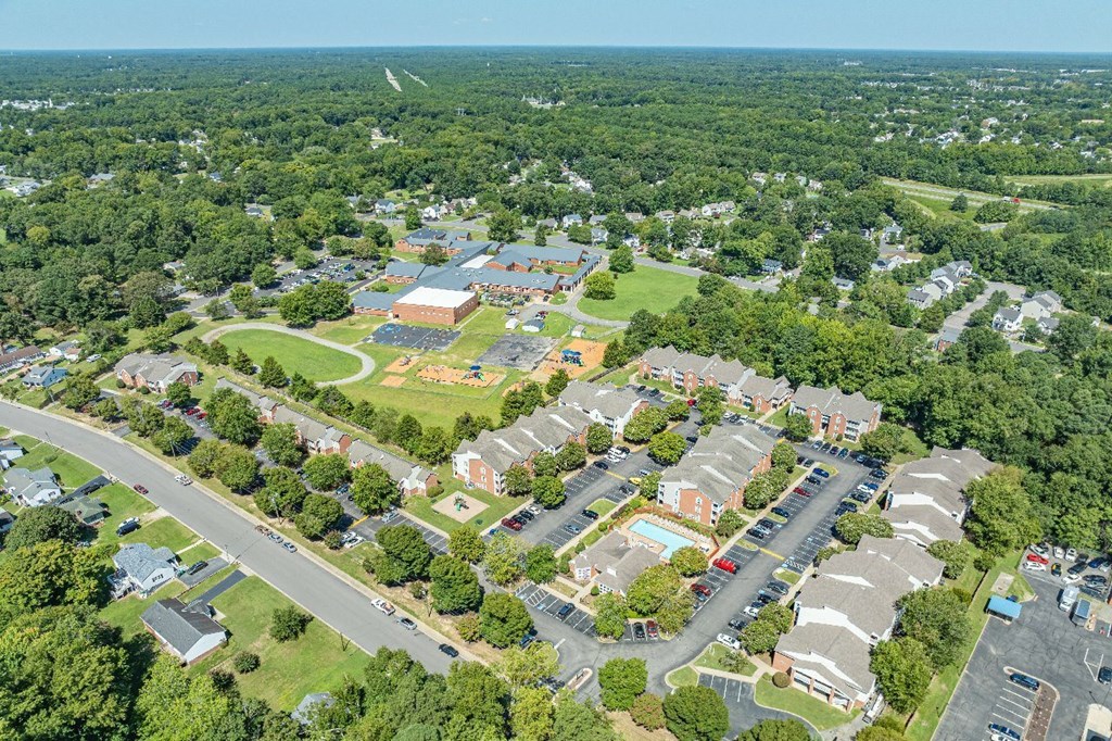 A bird's eye view of a residential area with a road running through it.