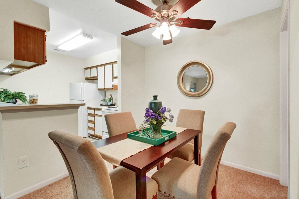 A dining room with a table set for four.
