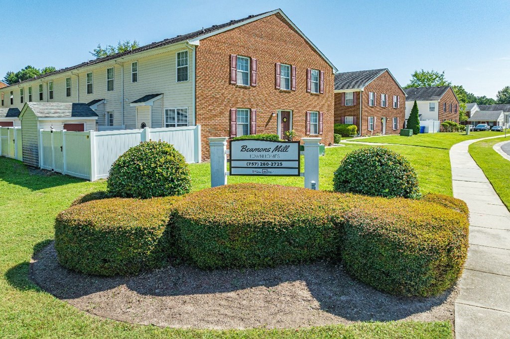 A sign in front of a building that says "Bellevue Apartments".