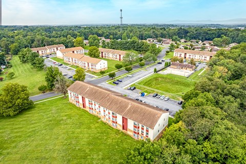 A bird's eye view of a residential area with houses and greenery.