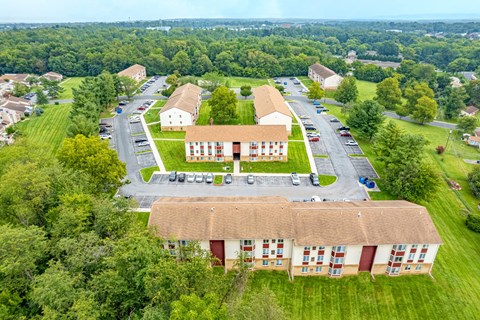 A large building with a parking lot in front of it.