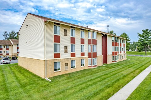 A large apartment complex with a red and white building.