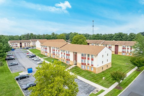 A large building with a parking lot in front of it.