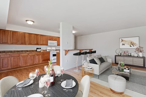 A dining room with a table set for a meal.