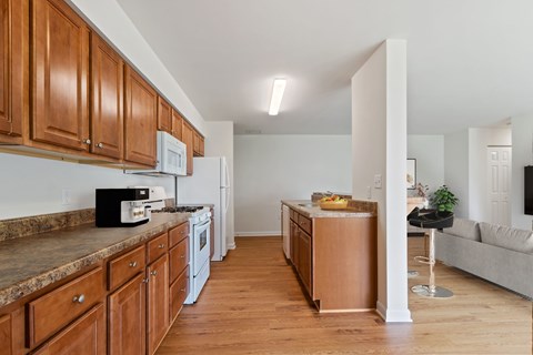 A kitchen with wooden cabinets and a white fridge.