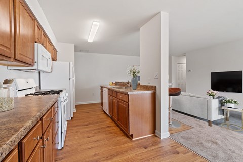 A kitchen with wooden cabinets and a white fridge.