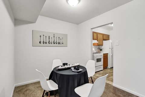 A dining room with a table set for two.