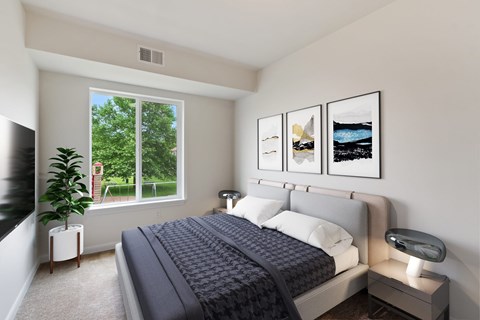 A bedroom with a large bed and a plant on the side table.