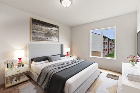 A bedroom with a large bed and a painting on the wall.