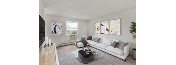 A living room with a white couch and a coffee table in front of it.