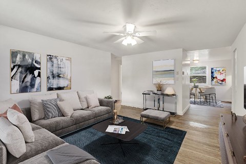 A living room with a grey couch and a coffee table.