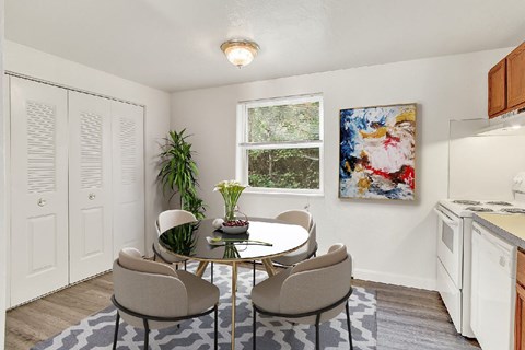 A dining room with a table and chairs.