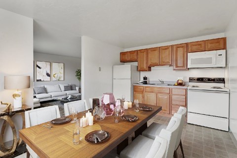 A modern kitchen with a dining table set for two.