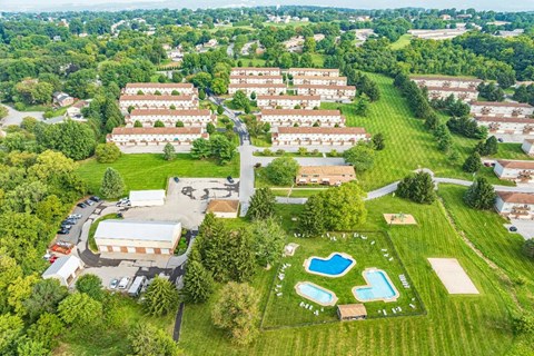 An aerial view of a residential area with a swimming pool.