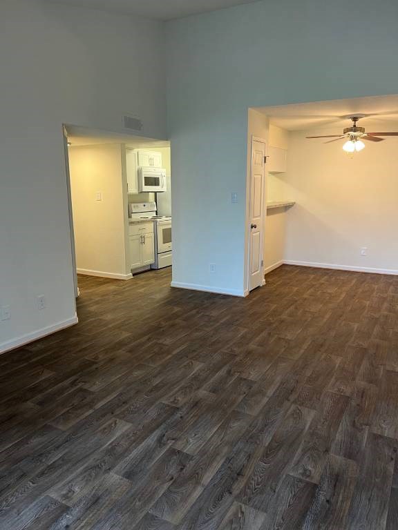 A room with a wood floor and a ceiling fan.