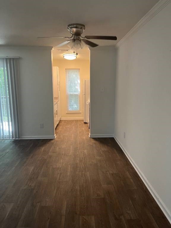 A room with a ceiling fan and wooden flooring.