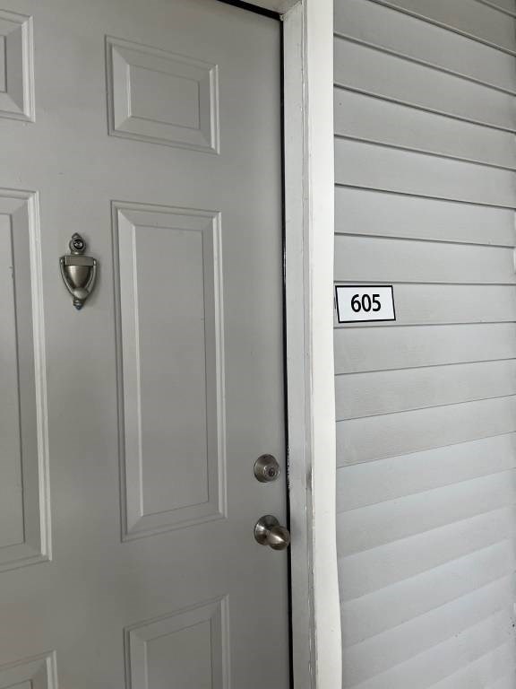 A white door with a mailbox on the side.