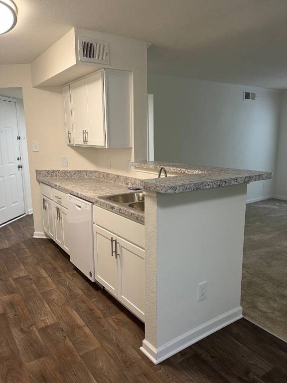 A kitchen with white cabinets and a granite countertop.