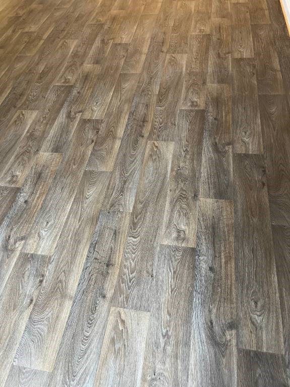 A wooden floor with a herringbone pattern.