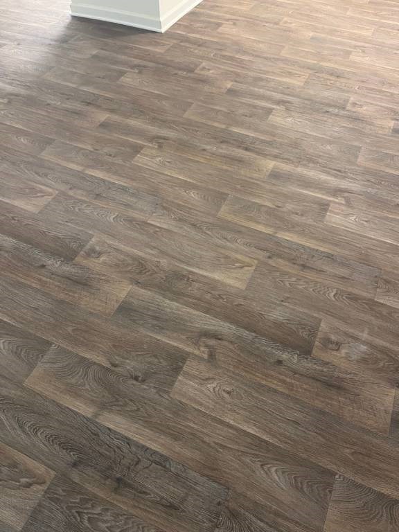 A wooden floor with a herringbone pattern is shown.