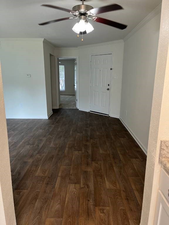 A room with a ceiling fan and wooden flooring.